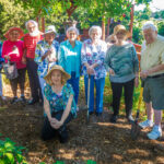 Mary Ott, lower, is pictured with her senior group who aids her in the garden at Merrill Gardens at Florence. Pictured are from left: John Hambrick, Betty Chasteen, Jimmie Butts, Geoff Keener, Lucy Thomas, Virginia Wilson, Peggy Ratliff, Emma Ginther, Bob Torbert, Paul Kollfrath, and Mary Donna Ott (kneeling).