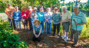 Mary Ott, lower, is pictured with her senior group who aids her in the garden at Merrill Gardens at Florence. Pictured are from left: John Hambrick, Betty Chasteen, Jimmie Butts, Geoff Keener, Lucy Thomas, Virginia Wilson, Peggy Ratliff, Emma Ginther, Bob Torbert, Paul Kollfrath, and Mary Donna Ott (kneeling).