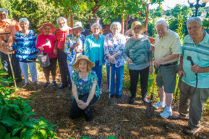 Mary Ott, lower, is pictured with her senior group who aids her in the garden at Merrill Gardens at Florence. Pictured are from left: John Hambrick, Betty Chasteen, Jimmie Butts, Geoff Keener, Lucy Thomas, Virginia Wilson, Peggy Ratliff, Emma Ginther, Bob Torbert, Paul Kollfrath, and Mary Donna Ott (kneeling).