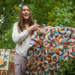 Stacey Putnam shows one of her quilts.