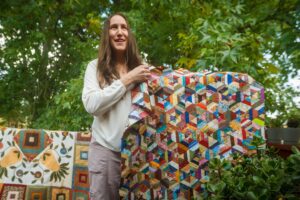 Stacey Putnam shows one of her quilts.