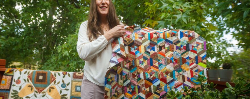 Stacey Putnam shows one of her quilts.