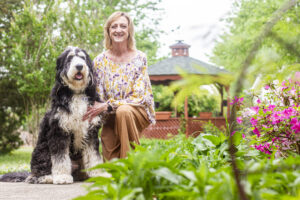 Amanda Simpson and her K9 partner, Bernie, pose for a portrait at the Renaissance of Florence on Tuesday, April 22, 2025, in Florence, Ala.