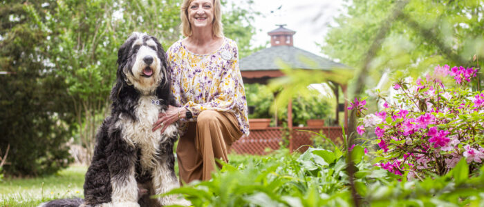 Amanda Simpson and her K9 partner, Bernie, pose for a portrait at the Renaissance of Florence on Tuesday, April 22, 2025, in Florence, Ala.