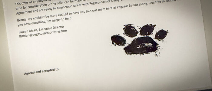 A paw print from K9 Bernie marks his official job acceptance at the Renaissance of Florence shown signed Tuesday, April 22, 2025, in Florence, Ala.