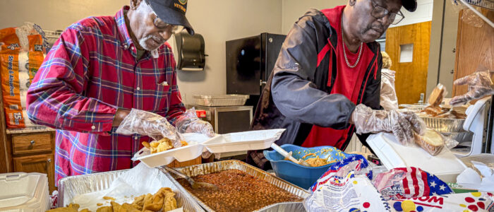 Ben Armstead, left, and Frank Averhart serve plates during a fundraising fish fry at the Michael Center on Saturday, May 3, 2025, in Sheffield, Ala.