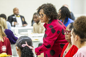 Dihanne Westfield , center, arrives to her table during a Florence Rotary Club meeting on Monday, May 5, 2025, in Florence, Ala.