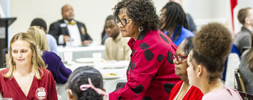 Dihanne Westfield , center, arrives to her table during a Florence Rotary Club meeting on Monday, May 5, 2025, in Florence, Ala.