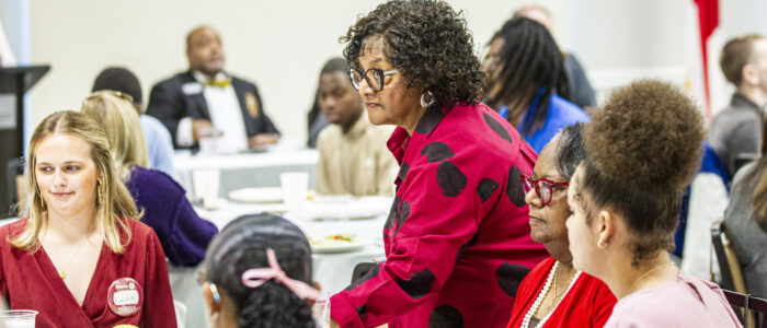 Dihanne Westfield , center, arrives to her table during a Florence Rotary Club meeting on Monday, May 5, 2025, in Florence, Ala.