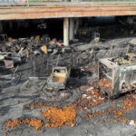 An aerial view of the 10 Freeway on Nov. 13, 2023, after a large pallet fire burned below, shutting the freeway to traffic.
