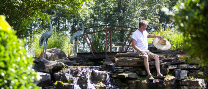 Andy Brown takes off his sunhat and places is it on a rock.