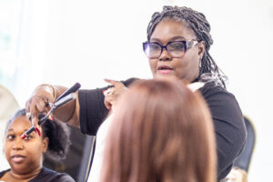 Cosmetology instructor LaSondra Stanford demonstrates the use of a hot comb
