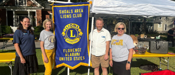 Steph Brenton, Peggy Sue Barnette, Justin Kimbrough and Nancy Sherman stand at the Lion’s Club booth