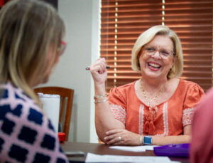 Nancy Ann Sherman, center, laugh