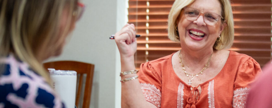 Nancy Ann Sherman, center, laugh