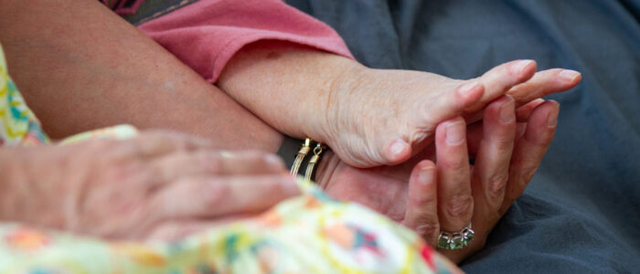 Nancy Ann Sherman holds hands with her sister Sara Jane Campbell,