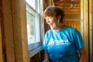 Jacqueline Broder looks out a recently installed window