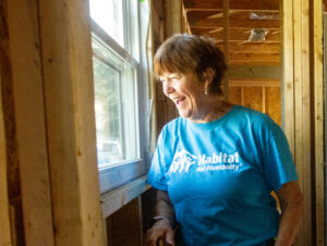 Jacqueline Broder looks out a recently installed window