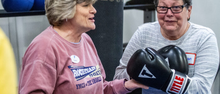 Rock Steady Boxing instructor Sara Huntley, left, instructs participants during a class