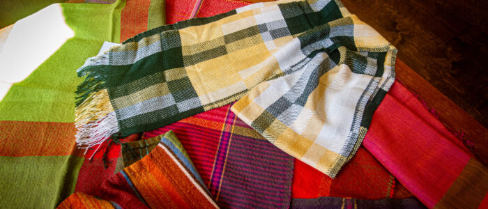 Brightly colored handwoven scarves and textiles