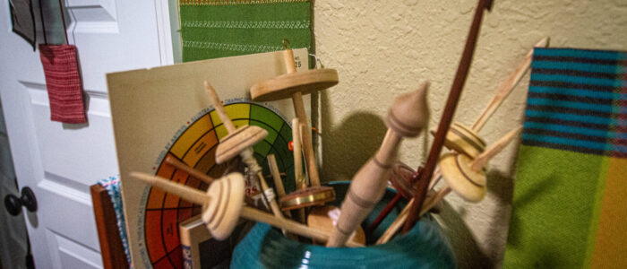 A vase filled with wooden drop spindles