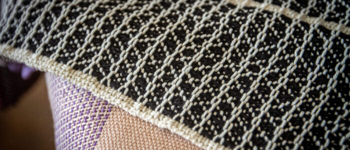 A textured black-and-white handwoven cloth